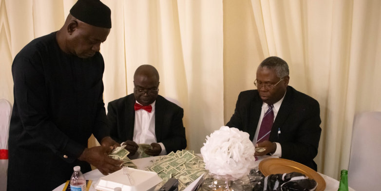 three men counting money