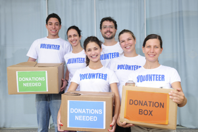 diverse volunteer group with food donation boxes